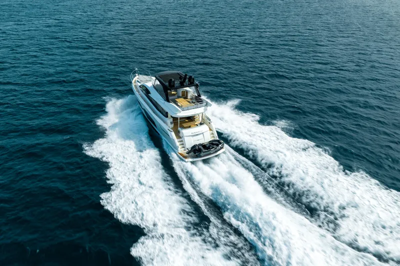 Mahalo Yacht Photos Pics 2018 Sunseeker Manhattan 66 yacht cruising on open sea, aerial view.