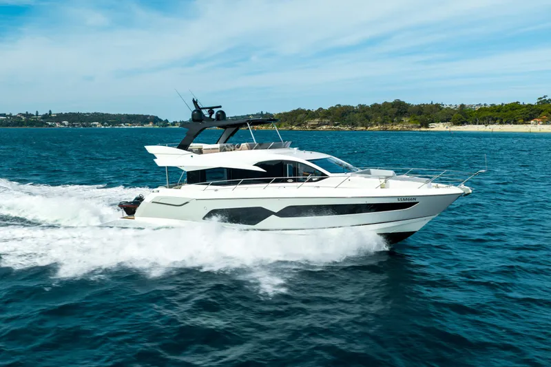 Mahalo Yacht Photos Pics 2018 Sunseeker Manhattan 66 yacht cruising on blue ocean waters.