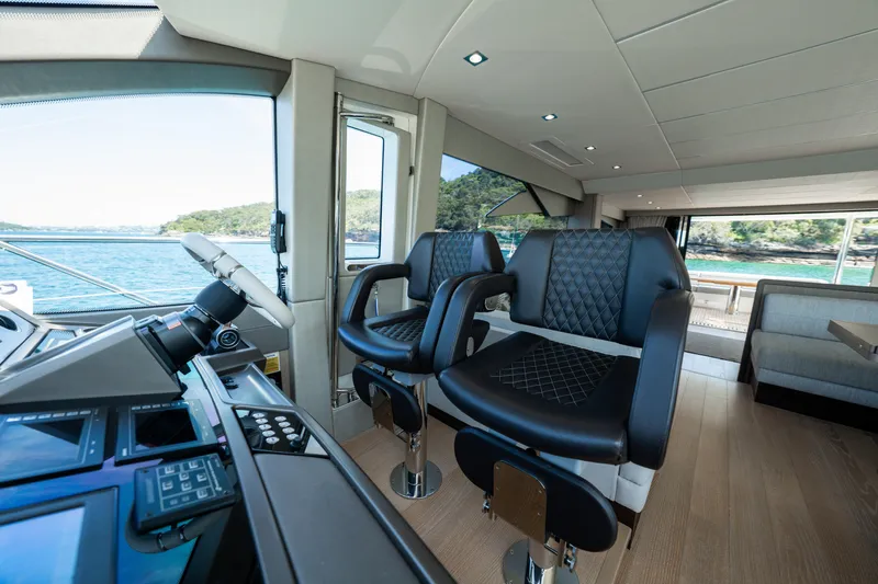 Mahalo Yacht Photos Pics Luxurious interior of 2018 Sunseeker Manhattan 66 yacht with leather seating and ocean view.