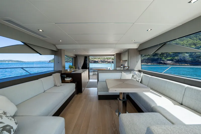 Mahalo Yacht Photos Pics Luxurious interior of 2018 Sunseeker Manhattan 66 yacht with ocean views and elegant seating.