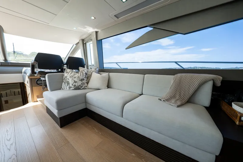 Mahalo Yacht Photos Pics Luxurious interior of 2018 Sunseeker Manhattan 66 yacht with modern seating and scenic views.