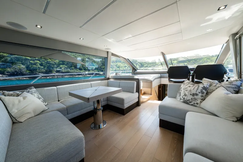 Mahalo Yacht Photos Pics Luxurious interior of 2018 Sunseeker Manhattan 66 yacht with elegant seating and scenic views.