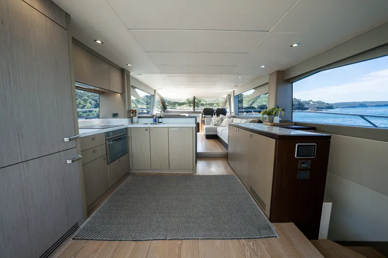 Mahalo Yacht Photos Pics Luxurious interior of 2018 Sunseeker Manhattan 66 yacht with modern kitchen and scenic ocean view.