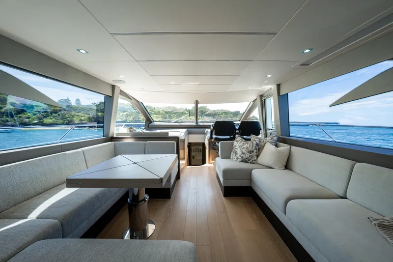 Mahalo Yacht Photos Pics Luxurious interior of 2018 Sunseeker Manhattan 66 yacht with spacious seating and scenic ocean views.