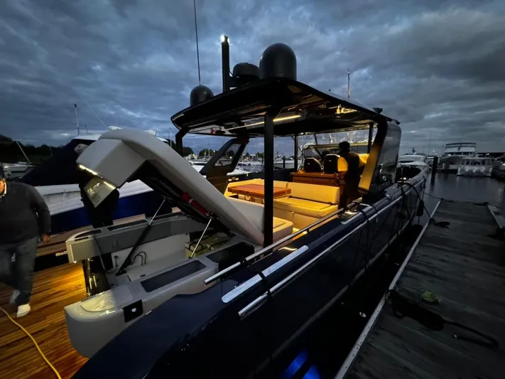 Imonna Yacht Photos Pics 2024 Cranchi A46 yacht docked at night, illuminated interior, sleek design.