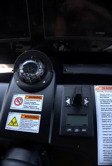 Imonna Yacht Photos Pics Control panel of 2024 Cranchi A46 yacht with compass and warning labels.