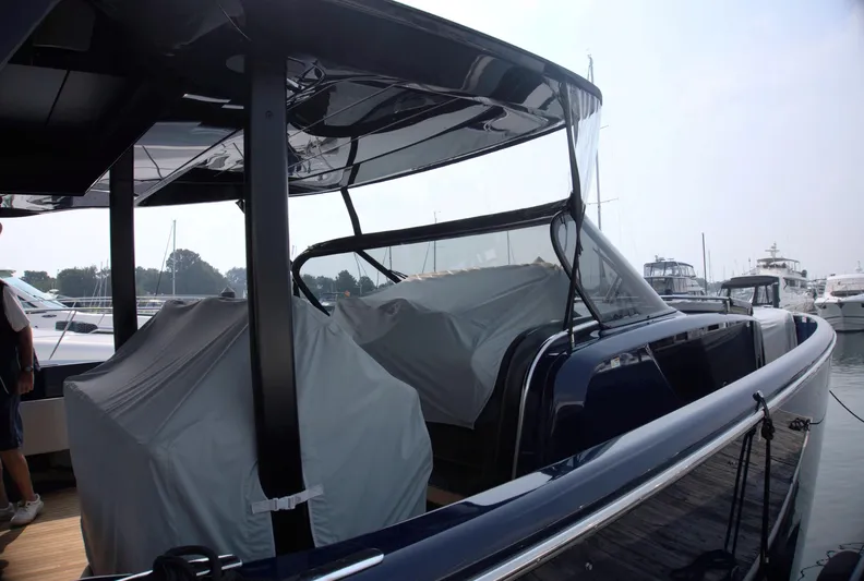 Imonna Yacht Photos Pics 2024 Cranchi A46 yacht docked, featuring sleek design and covered seating area.