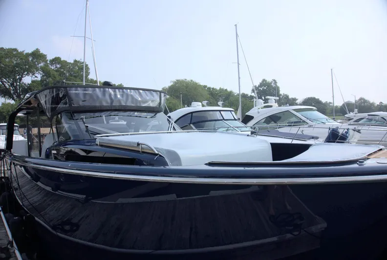 Imonna Yacht Photos Pics 2024 Cranchi A46 yacht docked at marina, sleek design, surrounded by other boats.