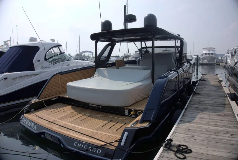 Imonna Yacht Photos Pics 2024 Cranchi A46 yacht docked at marina, featuring sleek design and spacious deck.
