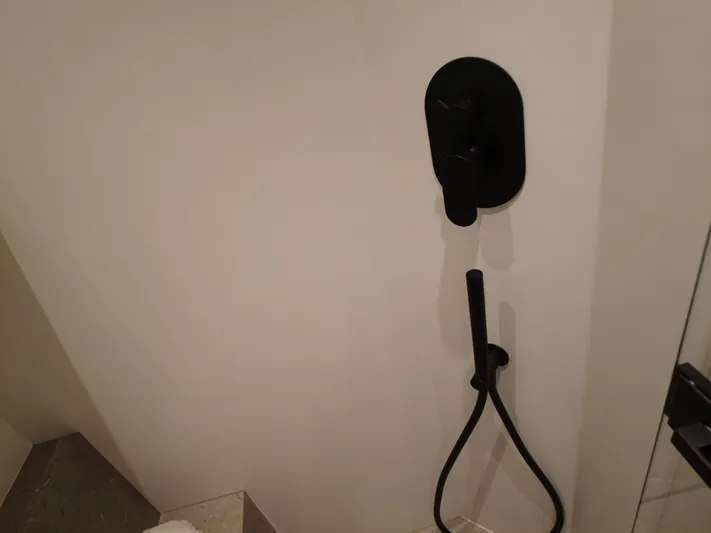 Imonna Yacht Photos Pics Black shower fixture in a modern bathroom on a 2024 Cranchi A46 yacht.