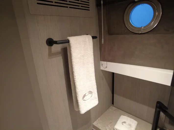 Imonna Yacht Photos Pics Interior of 2024 Cranchi A46 yacht bathroom with towel and porthole window.