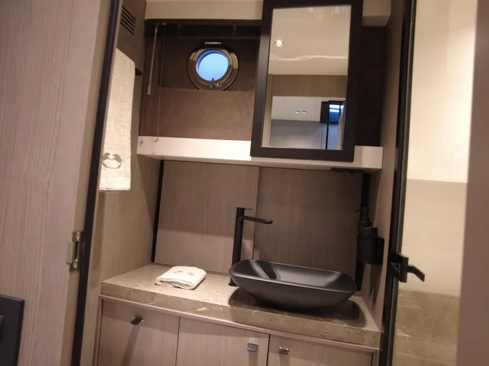 Imonna Yacht Photos Pics Luxurious bathroom interior of 2024 Cranchi A46 yacht with modern sink and porthole window.