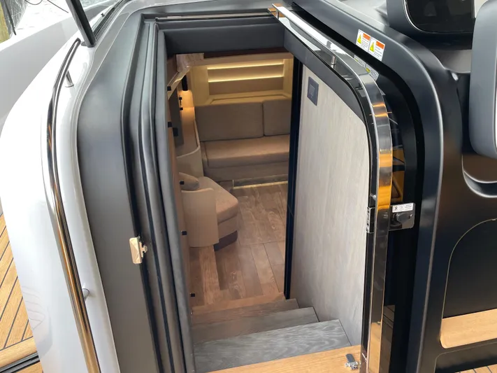 Imonna Yacht Photos Pics Interior view of 2024 Cranchi A46 yacht, featuring a modern staircase and cozy seating area.