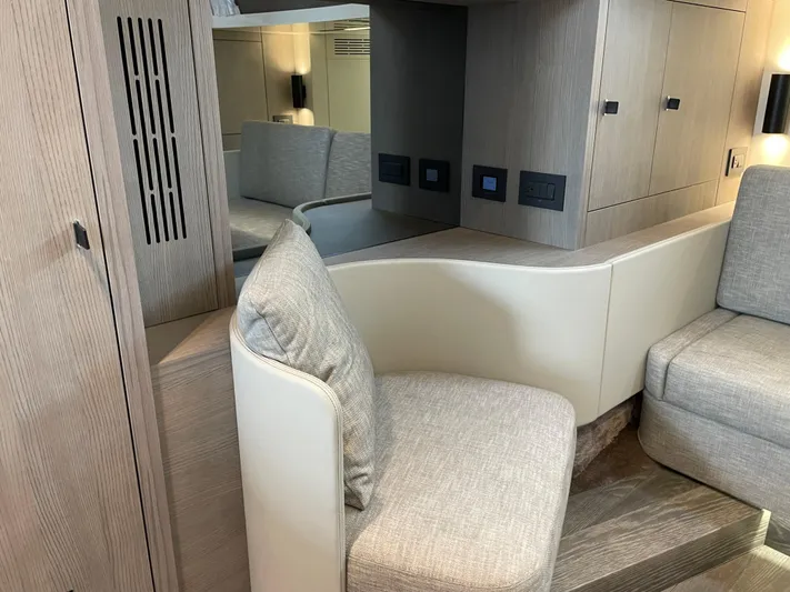 Imonna Yacht Photos Pics 2024 Cranchi A46 yacht interior with modern seating and wooden cabinetry.