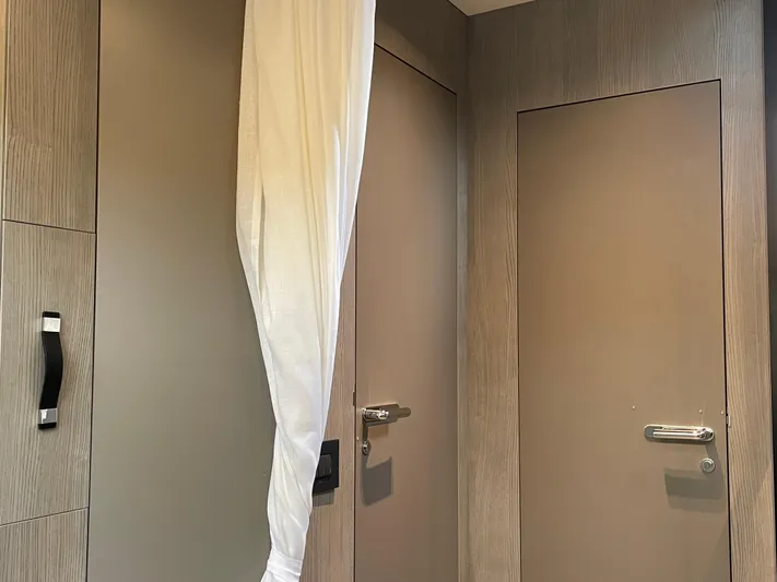 Imonna Yacht Photos Pics Interior of 2024 Cranchi A46 yacht with modern wood paneling and doors.