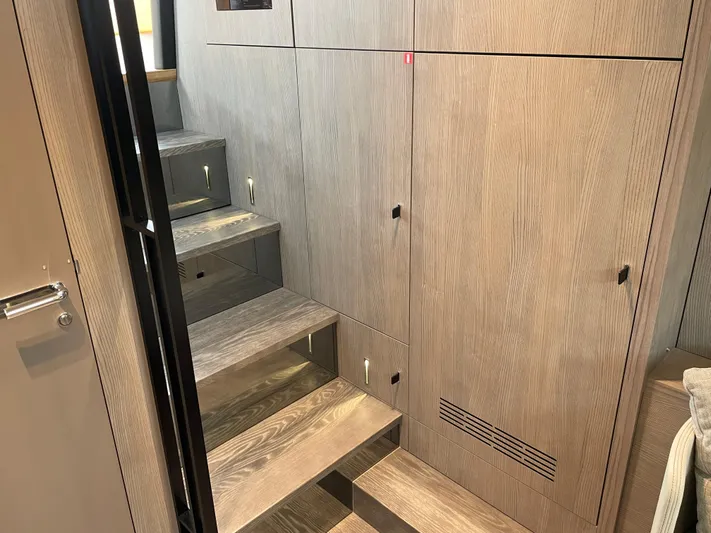 Imonna Yacht Photos Pics Interior of 2024 Cranchi A46 yacht with modern wooden stairs and cabinetry.