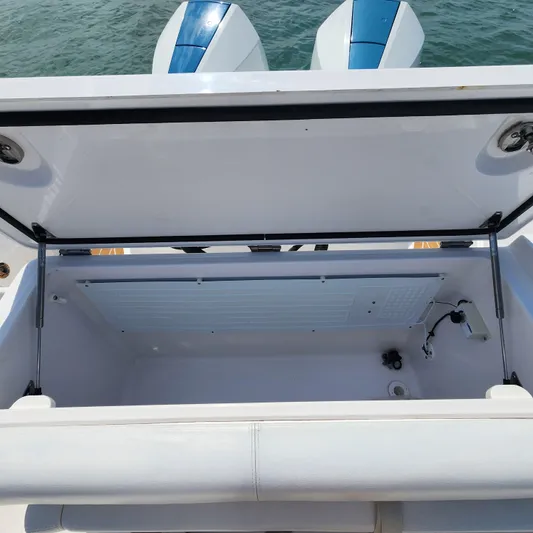  Yacht Photos Pics Open storage compartment on a 2022 Southport 30 FE boat, with visible dual engines.