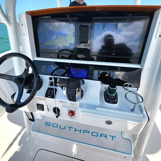  Yacht Photos Pics 2022 Southport 30 FE boat dashboard with dual screens and steering wheel.