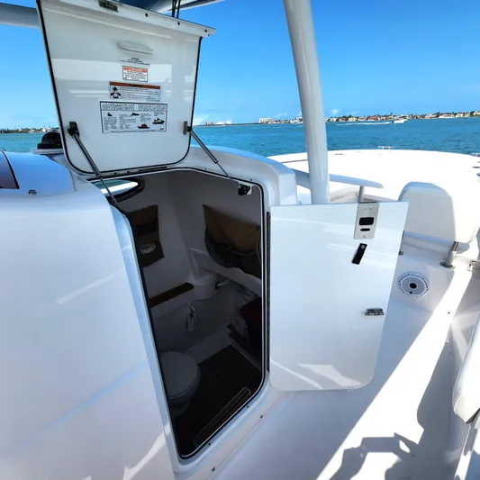  Yacht Photos Pics 2022 Southport 30 FE boat interior with open cabin door, showing compact restroom.