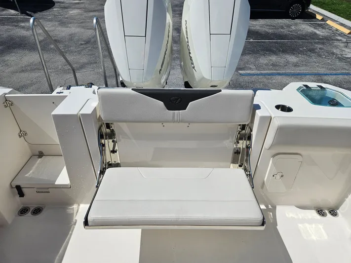  Yacht Photos Pics 2024 Sailfish 312CC boat with fold-down transom seat and twin outboard engines.