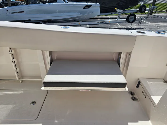 Yacht Photos Pics 2024 Sailfish 312CC boat with fold-down seat and storage compartment.