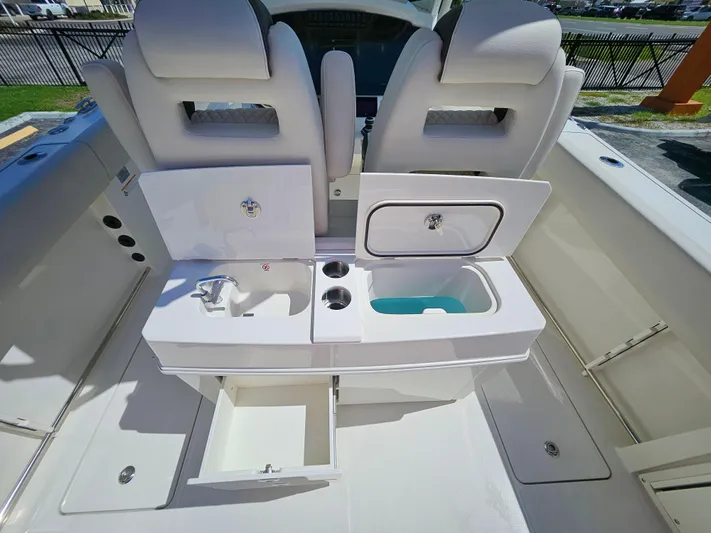  Yacht Photos Pics 2024 Sailfish 312CC boat interior with dual seats and storage compartments.