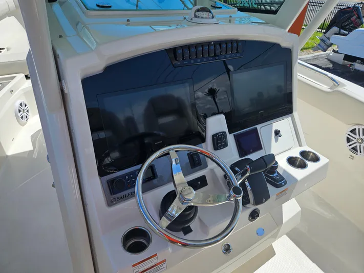  Yacht Photos Pics 2024 Sailfish 312CC boat helm with modern controls and dual displays.