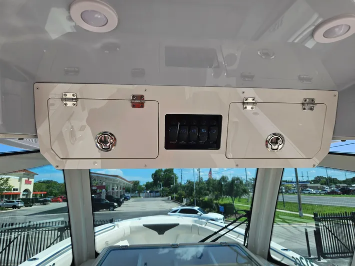  Yacht Photos Pics 2024 Sailfish 312CC boat console with storage compartments and control panel.