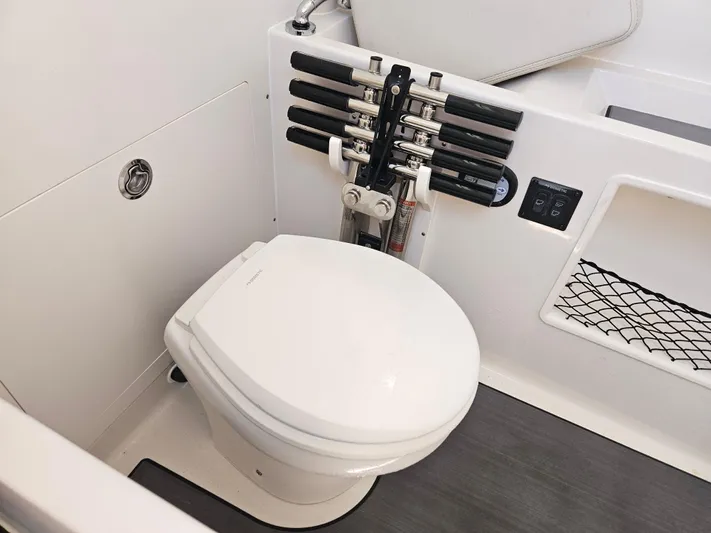  Yacht Photos Pics 2024 Sailfish 312CC boat interior with toilet and rod holders.