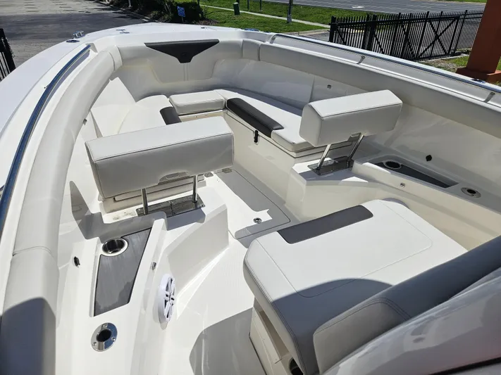  Yacht Photos Pics 2024 Sailfish 312CC boat interior with white cushioned seating and cup holders.