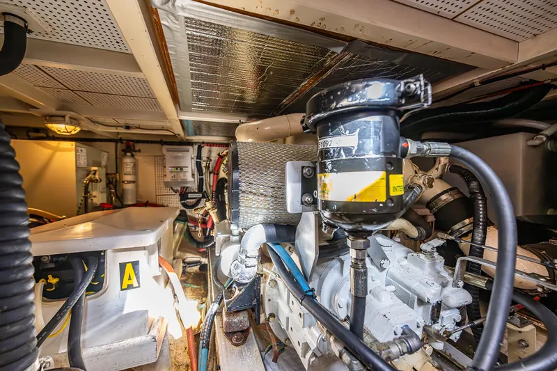 Vesper Yacht Photos Pics Engine room of a 1990 Grand Banks Sedan boat with visible machinery and equipment.