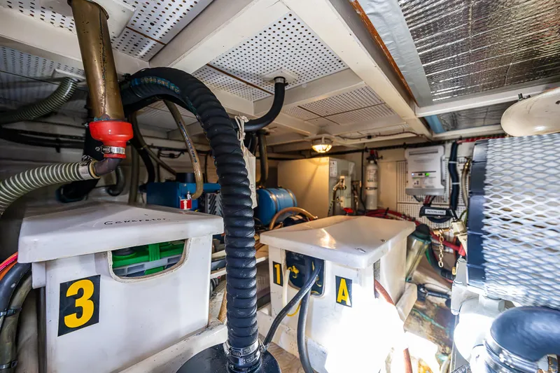 Vesper Yacht Photos Pics Engine room of a 1990 Grand Banks Sedan boat with various equipment and components.