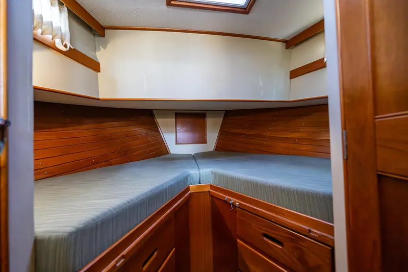Vesper Yacht Photos Pics 1990 Grand Banks Sedan interior cabin with twin beds and wooden cabinetry.