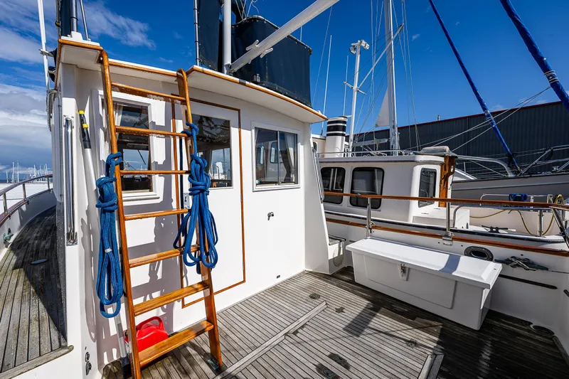 Vesper Yacht Photos Pics 1990 Grand Banks Sedan boat deck with wooden ladder and blue ropes.