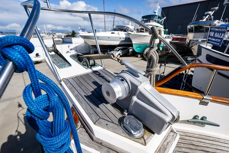 Vesper Yacht Photos Pics 1990 Grand Banks Sedan boat deck with winch and blue rope.