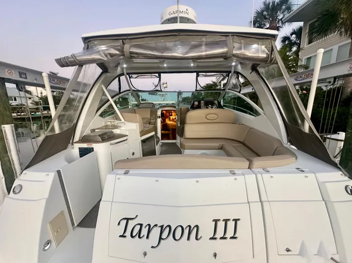 Tarpon III Yacht Photos Pics 2009 Cruisers Yachts 360 Express, rear view, named "Tarpon III," docked with seating area visible.
