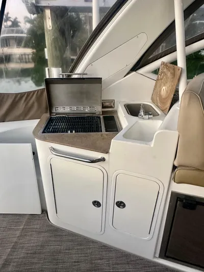 Tarpon III Yacht Photos Pics 2009 Cruisers Yachts 360 Express interior with grill and sink setup.