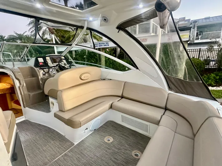 Tarpon III Yacht Photos Pics 2009 Cruisers Yachts 360 Express interior with beige seating and modern helm.