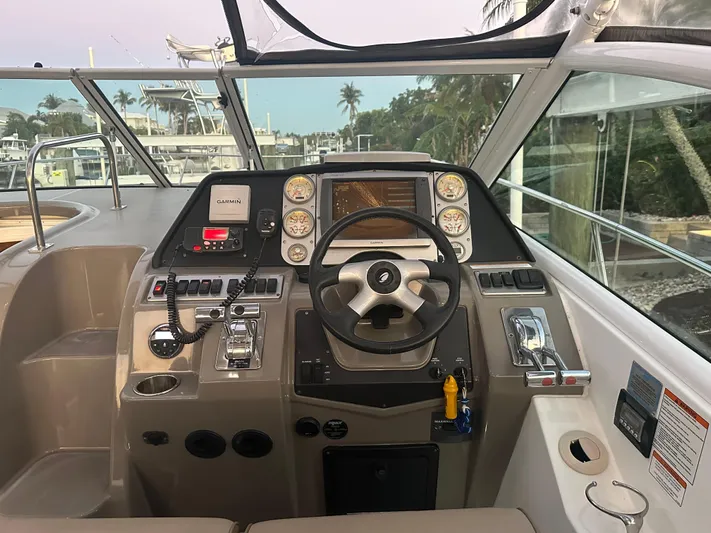 Tarpon III Yacht Photos Pics Helm of 2009 Cruisers Yachts 360 Express with steering wheel and navigation controls.