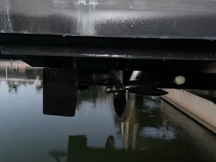 Tarpon III Yacht Photos Pics 2009 Cruisers Yachts 360 Express propeller and rudder detail near water surface.