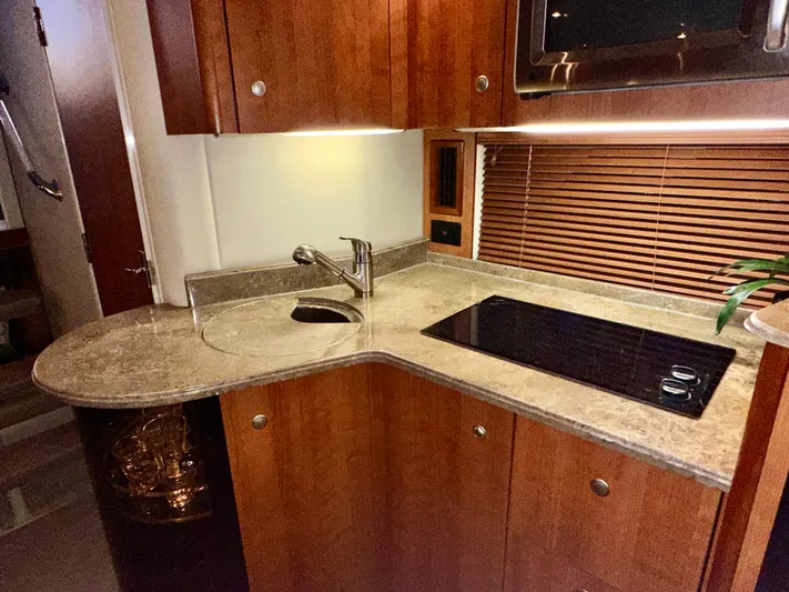 Tarpon III Yacht Photos Pics Luxurious 2009 Cruisers Yachts 360 Express kitchen with sleek countertops and modern appliances.