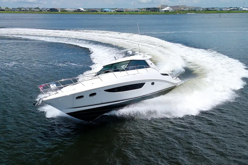 Sun Daze Yacht Photos Pics 2013 Sea Ray 450 Sundancer yacht making a sharp turn on open water.