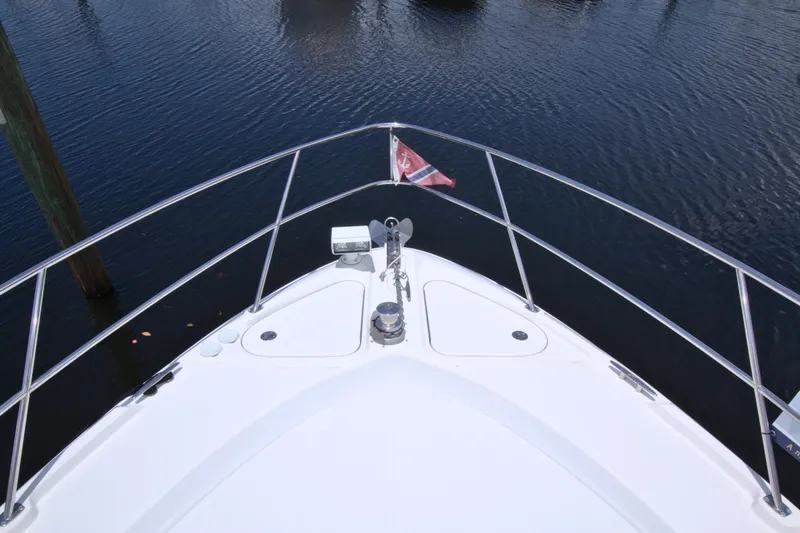 Sun Daze Yacht Photos Pics Bow view of 2013 Sea Ray 450 Sundancer yacht on calm water.