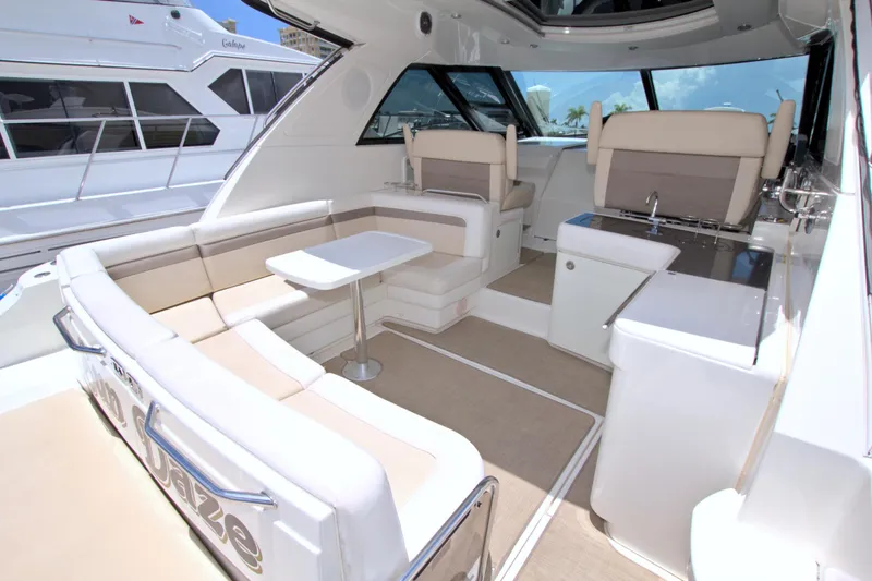 Sun Daze Yacht Photos Pics Luxurious interior of 2013 Sea Ray 450 Sundancer yacht with seating and table.