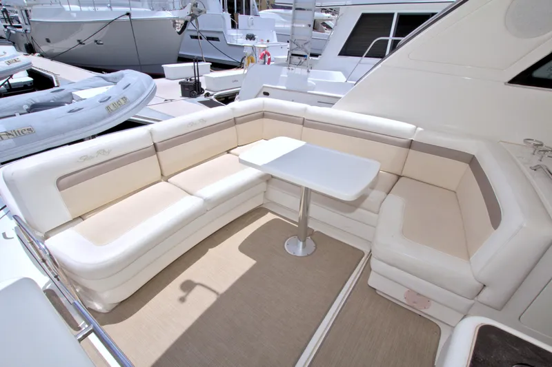 Sun Daze Yacht Photos Pics Luxurious seating area on 2013 Sea Ray 450 Sundancer yacht with white cushions and table.
