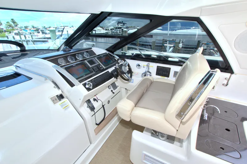 Sun Daze Yacht Photos Pics Helm of 2013 Sea Ray 450 Sundancer with modern controls and comfortable seating.