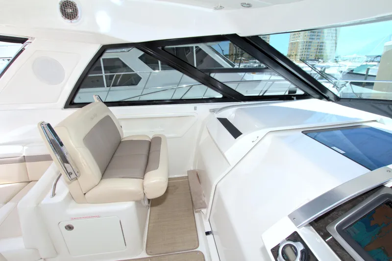 Sun Daze Yacht Photos Pics Interior of 2013 Sea Ray 450 Sundancer yacht with beige seating and modern dashboard.