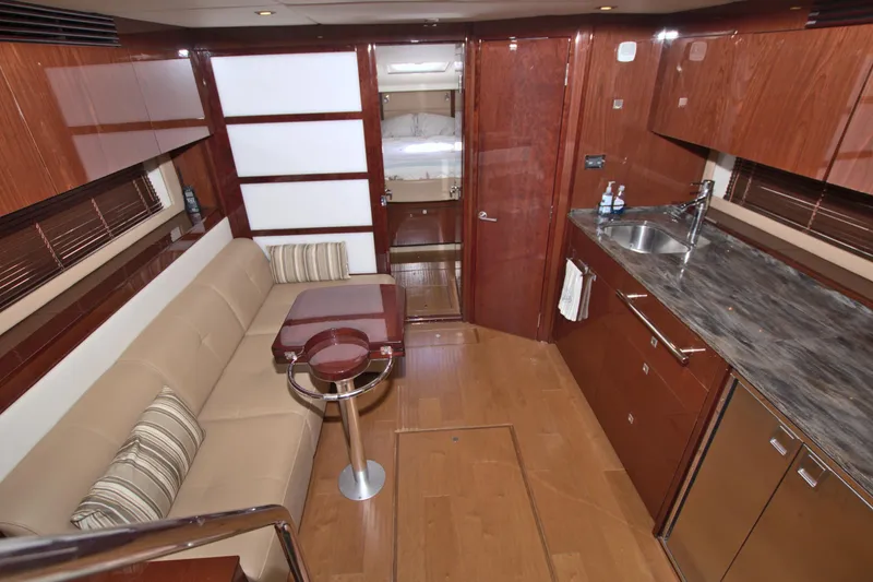 Sun Daze Yacht Photos Pics Luxurious interior of 2013 Sea Ray 450 Sundancer yacht with modern kitchen and seating area.