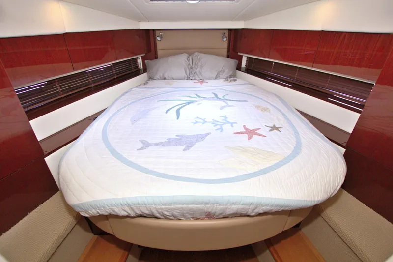 Sun Daze Yacht Photos Pics Luxurious bedroom interior of 2013 Sea Ray 450 Sundancer yacht with nautical-themed bedding.