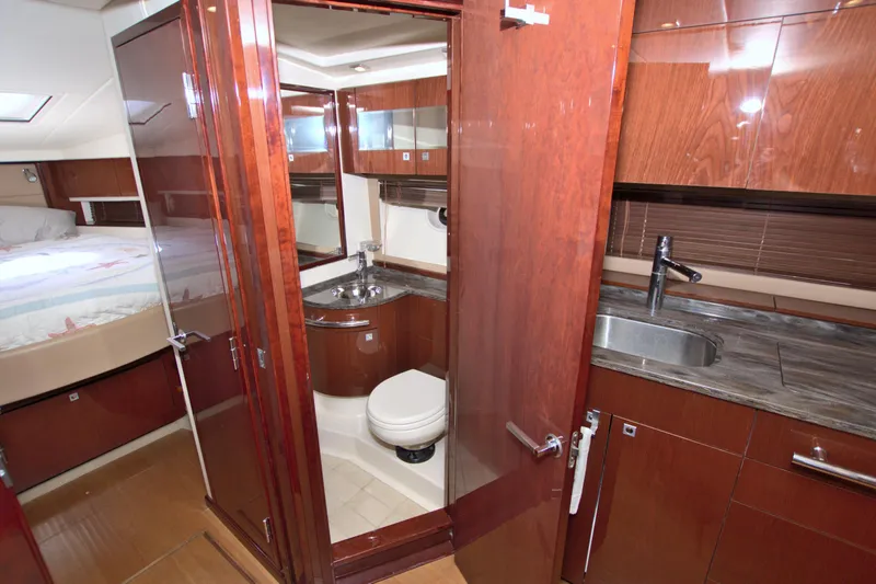 Sun Daze Yacht Photos Pics Luxurious interior of 2013 Sea Ray 450 Sundancer yacht with wood finishes and modern amenities.
